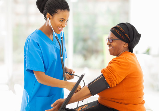 A doctor taking the blood pressure of a woman